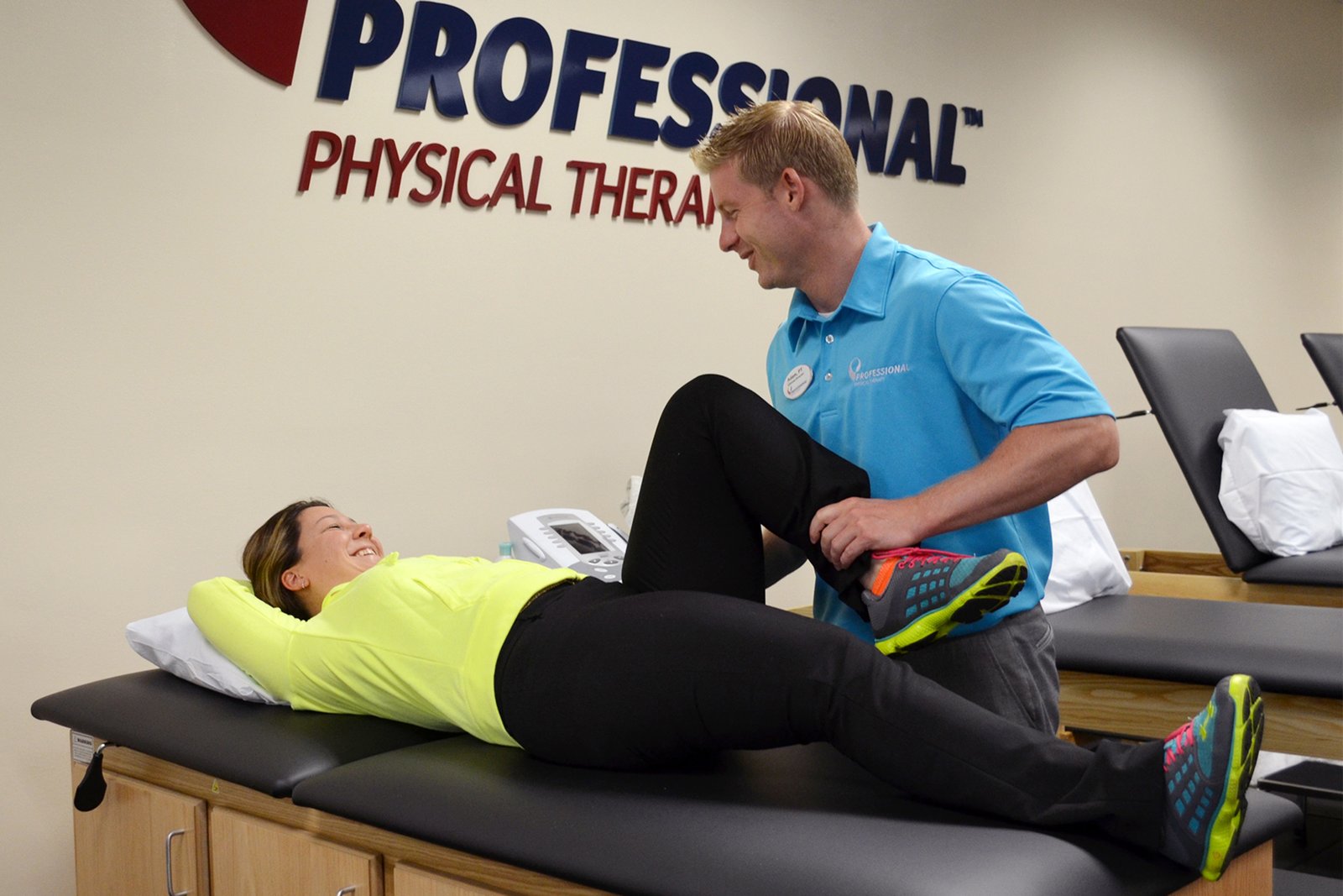 Physiotherapist providing leg rehabilitation therapy
